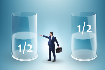 Businessman in half empty half full glass concept