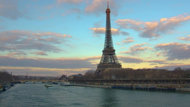 The famous bridge over the river Seine is one of the most popular attractions in Paris. The old subway passes over the bridge. Great view of the Eiffel Tower at sunset