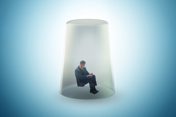 Businessman trapped in transparent glass