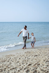 father and son wake up and walk on the ocean