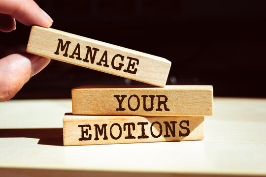 Wooden blocks with words 'Manage your emotions'.