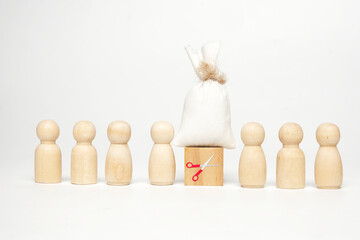 A picture of scissors at wooden block with money bag on top splitting two groups of peg doll....