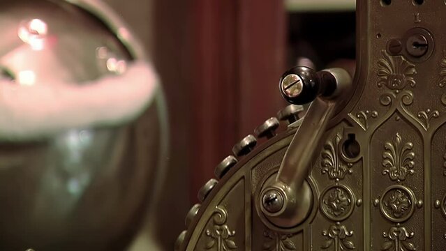 Man using an Antique Crank-operated Cash Register. Close Up. 4K Resolution.