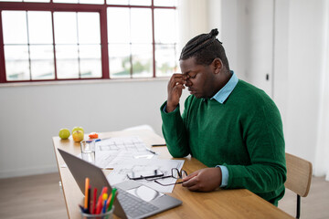 Black Man Having Sore Eyes After Work Sitting In Office