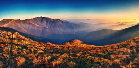 Fototapeta na wymiar Mountain silhouettes in the fog. Graphic landscape on the theme of mountains