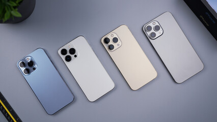 Smartphones Blue, Silver, Gold, and Graphite colors on Desk