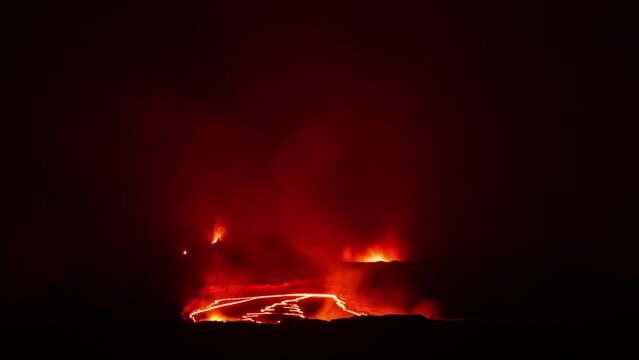 Fiery glow of the lava lake of Kilauea's active volcano crater at nightfall at Volcanoes National Park in Big Island, Hawaii.