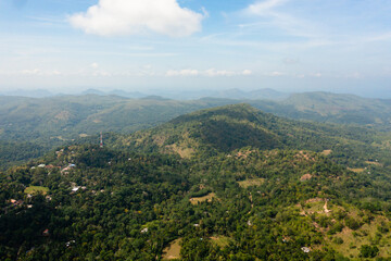 Fototapeta na wymiar Aerial view of Mountains with rainforest and clouds. Sri Lanka. Slopes of mountains with evergreen vegetation.