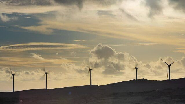 Timelapse - Arieal view of multiple wind turbines on the hills at Sounth Point in Hawaii