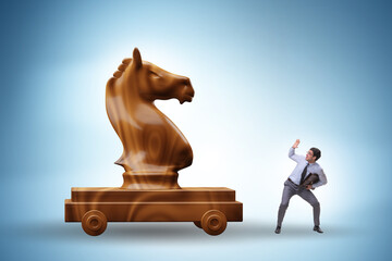 Businessman and trojan horse in trap concept - obrazy, fototapety, plakaty