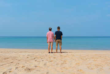 A couple of senior asian adults standing on the beach
