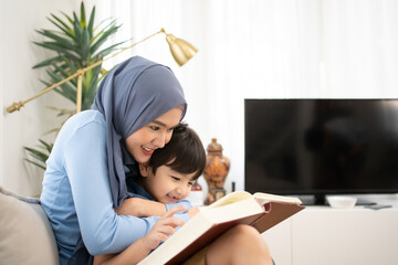 Mother and son spend time together and hugging gives a tulip flower on mother’s day together at home.