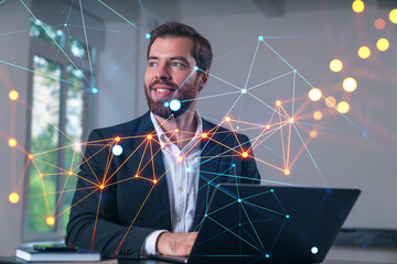 Smiling businessman in formal wear working on laptop at office workplace with smartphone and notebooks. Concept of successful business deal, agreement. Social network icons.