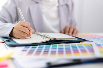 Businesswoman working and analyzing about color with color bar