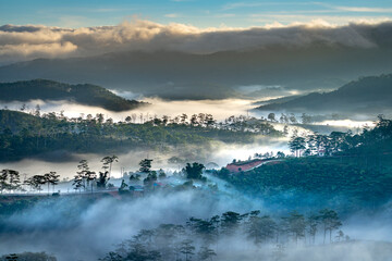 Beautiful images of the radiant dawn with reflecting rays through the fanciful clouds on over the pine forests, which created an impressive breathtaking scene of highlands in the morning in Dalat, VN