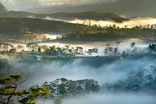 Beautiful images of the radiant dawn with reflecting rays through the fanciful clouds on over the pine forests, which created an impressive breathtaking scene of highlands in the morning in Dalat, VN