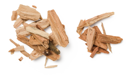 closeup of two piles of cedar or palo santo incense, wood chips isolated over a transparent background, top view / flat lay