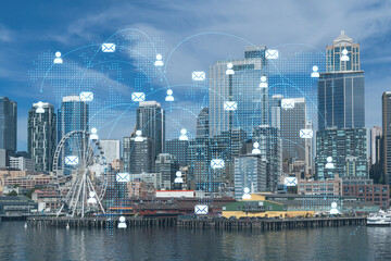 Seattle skyline with waterfront view. Skyscrapers of financial downtown at day time, Washington, USA. Social media hologram. Concept of networking and establishing new people connections
