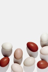 Frame from Easter eggs red gradient color with hard Shadow at sunlight, light background. Chicken eggs minimal flat lay, traditional food and symbol of Easter, monochrome color, top view