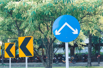 blue arrow sign indicating a two way road