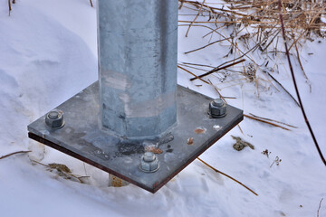 Bolted connection of the mast with the foundation on a winter day