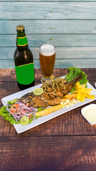 chita or fried fish with fried yucca and ceviche, with ice cold beer