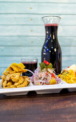 ceviche, chicharrón and rice with seafood, chicha morada. peruvian food
