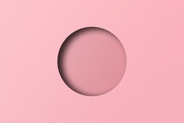 Pink paper cut into circular holes put together with light and shadow.