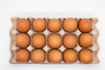Brown eggs in an egg carton, top view