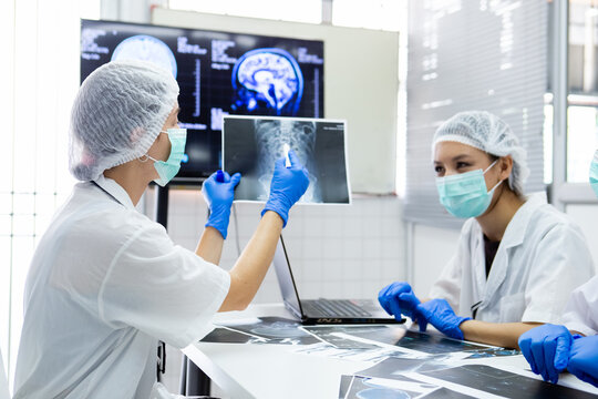 group of medical student study in class room. medical students studying human brain disease diagnosis through learning from X-ray film. Learn about brain surgery for diagnosis.