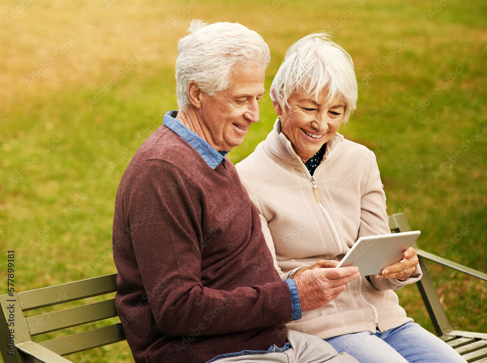 Wall mural Internet, park and senior couple with a tablet for communication, video call and scrolling. Nature, hug and elderly man and woman with technology for social media and reading an email in Argentina