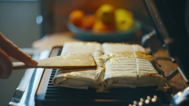 Checking the readiness of homemade shawarma in an electric grill.