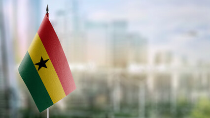 Small flags of the Ghana on an abstract blurry background