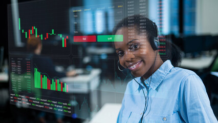 African American woman works as a call center operator.Stock charts. Broker terminal.