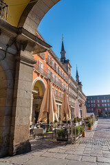One of the gateways to the main square of Madrid with its typical old buildings around the square, Spain.