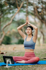 Portrait of young woman practicing yoga in garden.female happiness.  in the park blurred background. Healthy lifestyle and relaxation concept.