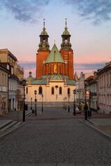 Fototapeta na wymiar Historical road leading towards Gniezno Royal Cathedral on a sunset.