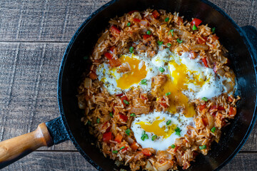 Boiled rice with fried eggs, red peppers, tomato and onions, closeup, Ukraine. Food background. Healthy food