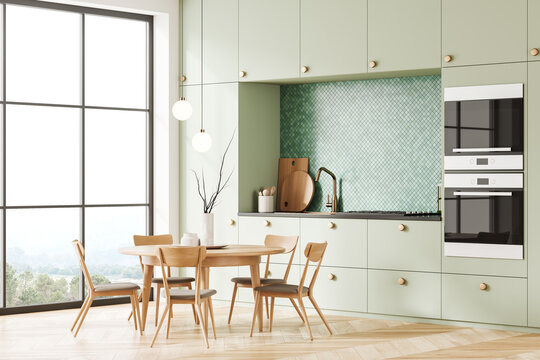 Green mosaic kitchen interior with table
