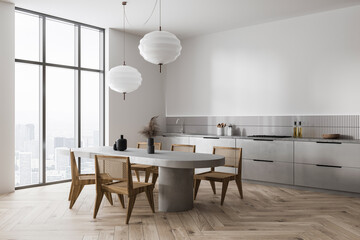 Luxury home kitchen interior with cooking and dining corner, panoramic window