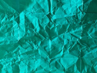 Obraz premium Green paper texture with crumpled folds background