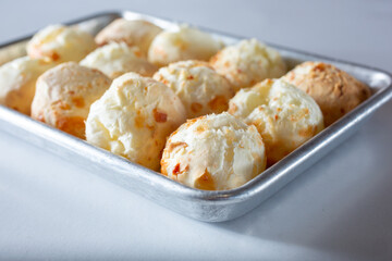 A view of a tray full of a Brazilian cheese bread known as Pão de queijo.