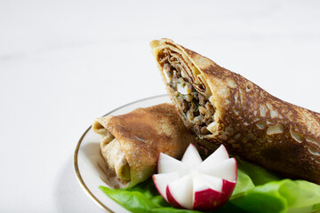 A view of a plate of blintzes.