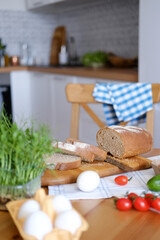 Freshly baked bread on the table cut into slices for sandwiches for breakfast or snack