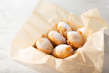 A view of a basket of deep fried cookie sandwiches.