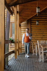 Fototapeta premium portrait of the groom in a gray suit and an orange vest