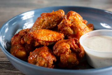 A closeup view of a plate of buffalo wings.