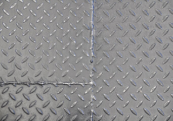 Close-up of the texture of a corrugated steel sheet. Weld seam.