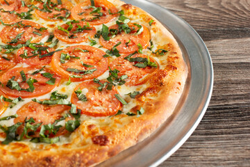 A view of a rustic Margherita pizza pie.
