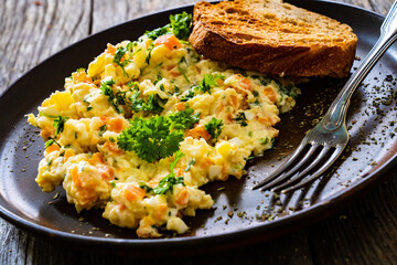 Vegetable mayonnaise salad with hard boiled eggs on white table
